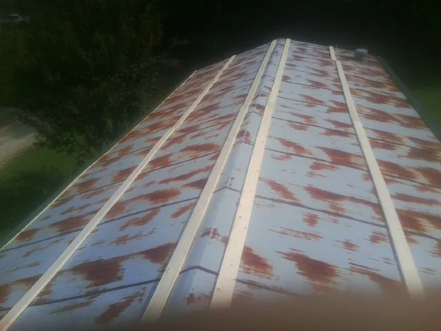 Rusted metal roof panels with new wood purlins before replacement — Storm Damage Roof Repair in Changewater by Roofing Brothers